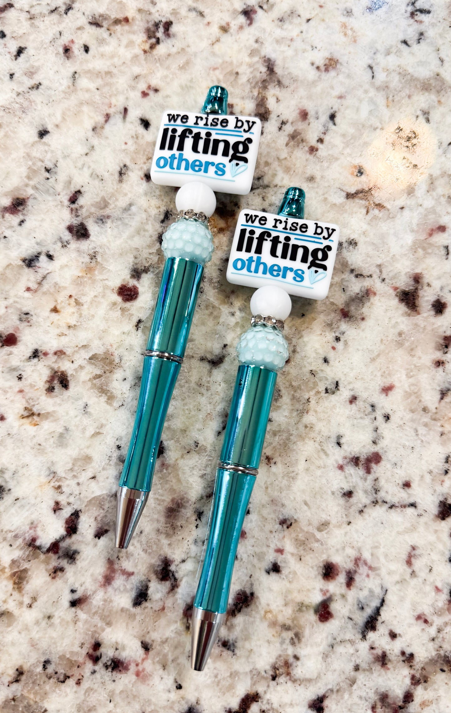 We Rise by Lifting Others Teal Refillable Pen